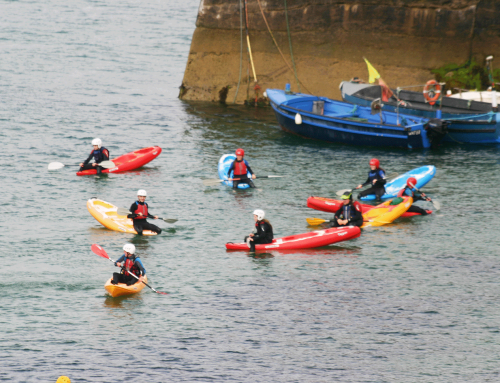 Ecole de Mer students learning kayaking skills on the boat cove